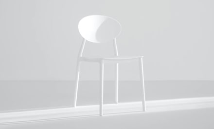 Sleek white chair in a white room